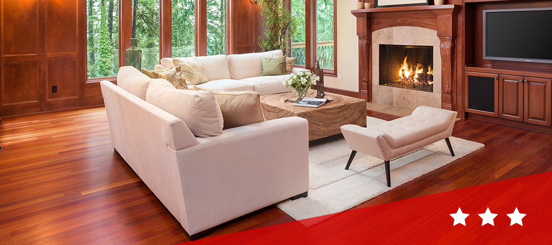 couch in front of fireplace on hardwood floors