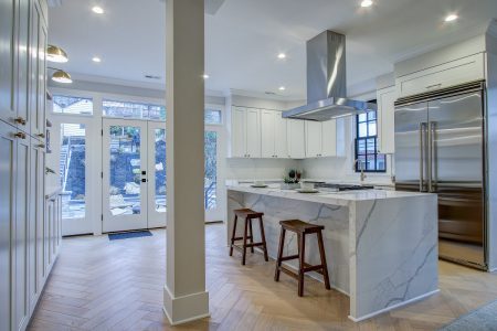 A kitchen with herringbone hardwood floors