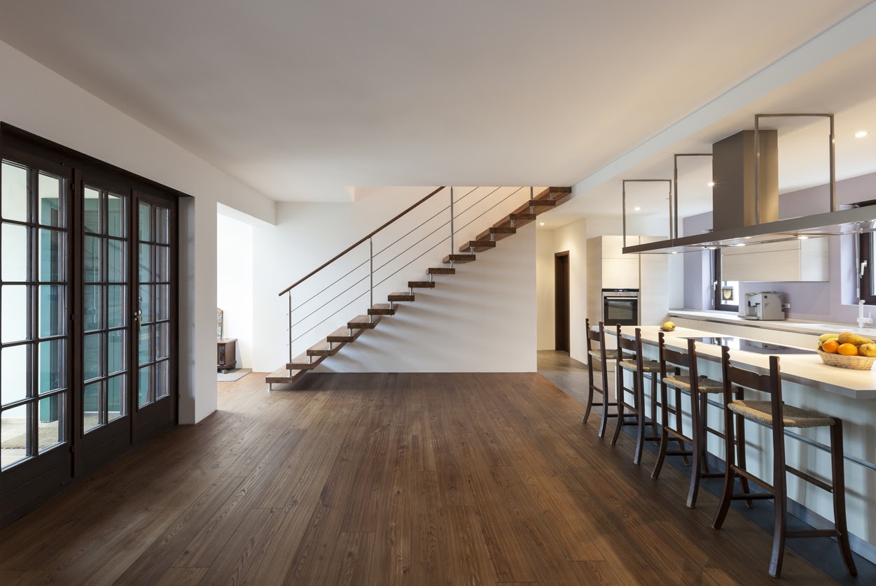 The interior of a loft with hardwood floors with no need to remove black stains.